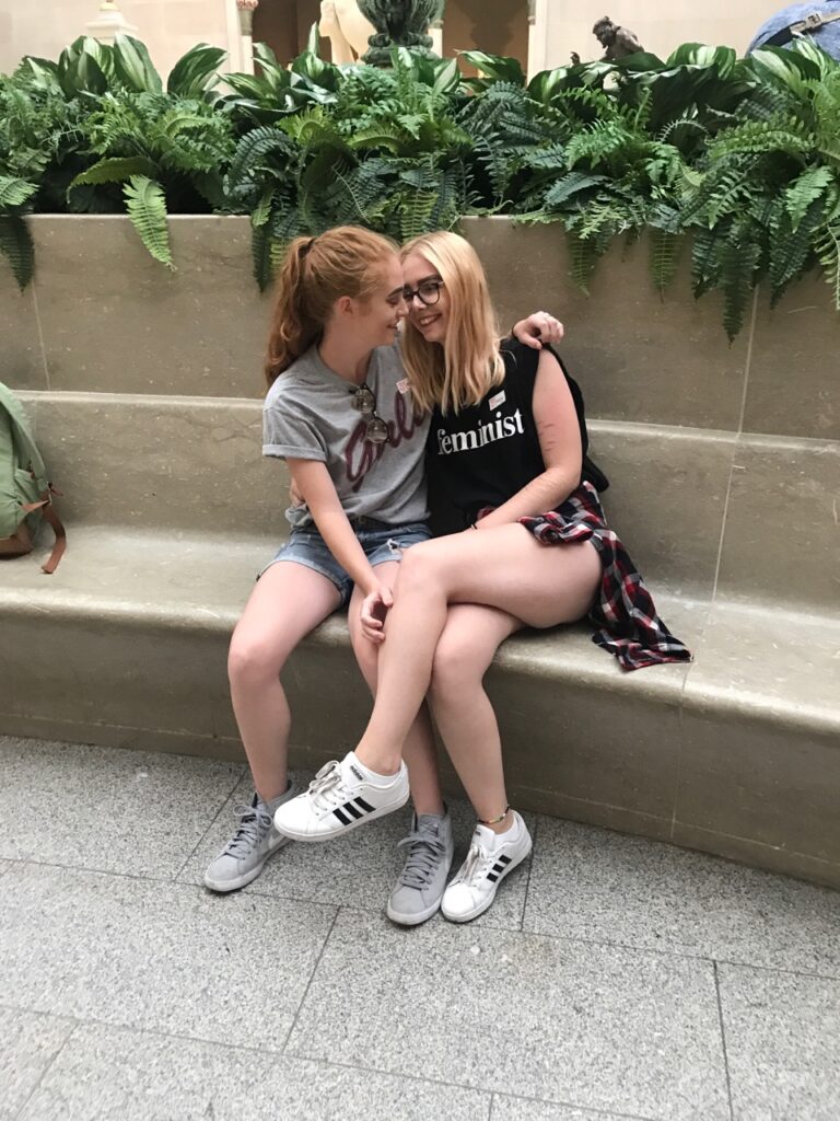 Decorative. The author and their girlfriend sit together on a bench, smiling. 