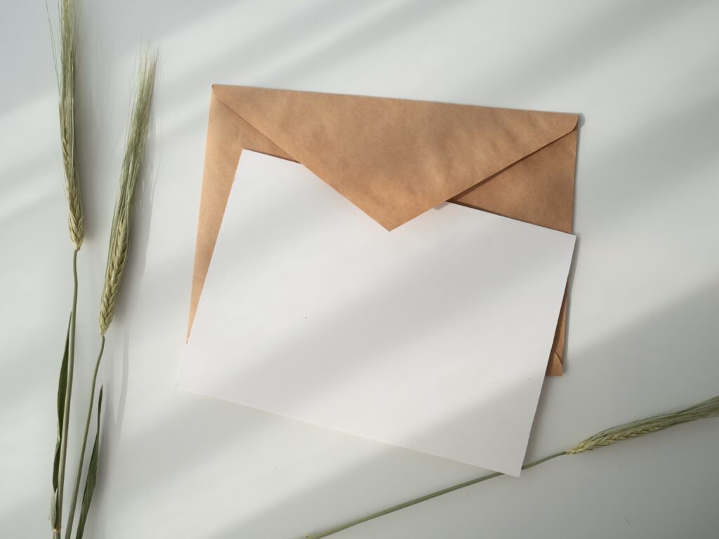 Decorative. A piece of paper sits inside an envelope.
